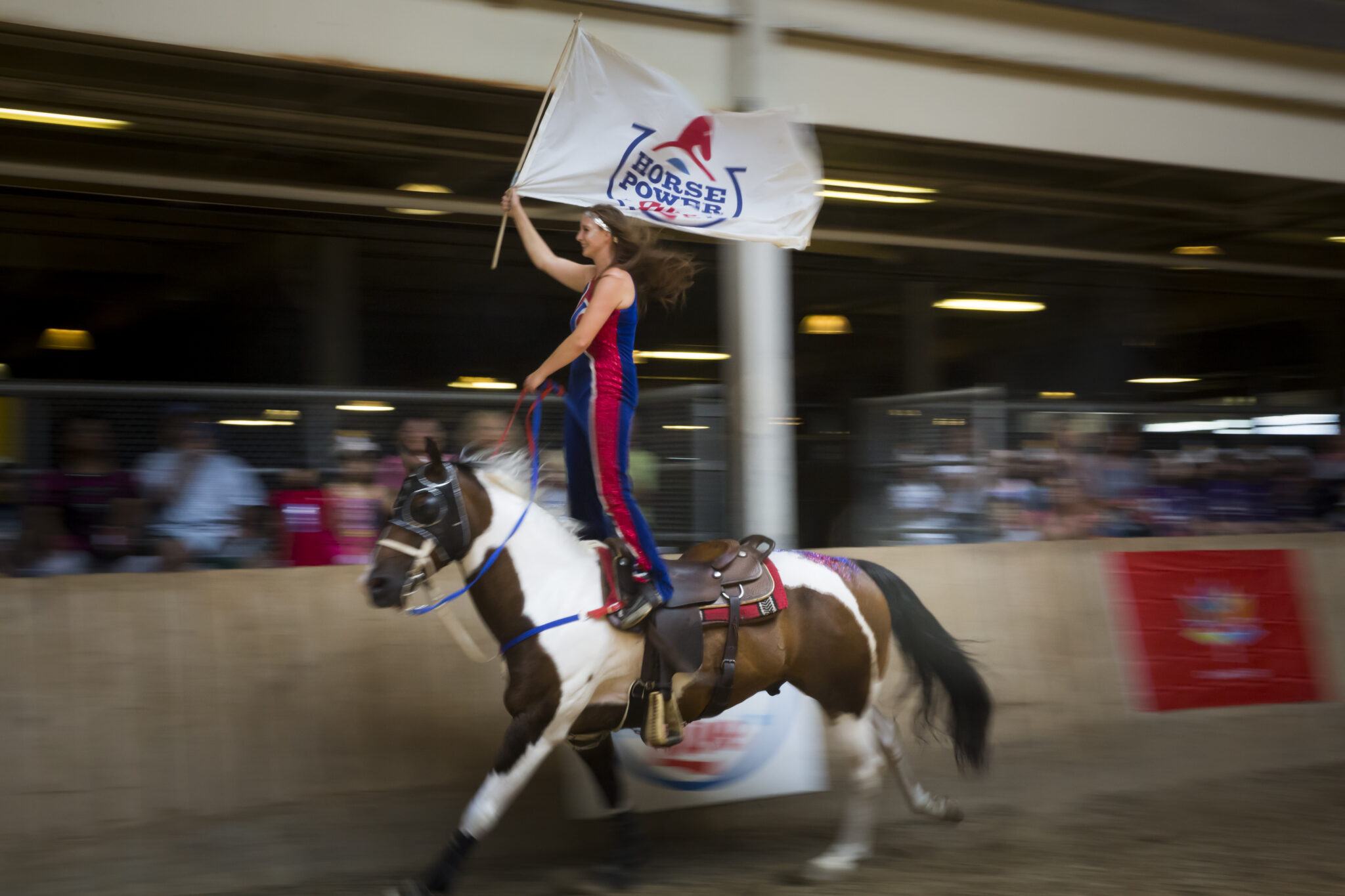 Young woman on a horse performing